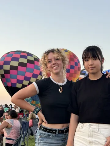 two girls by hot air balloons