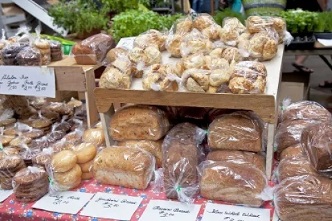 Packaged home-prepared baked goods on table at Farmers Market.